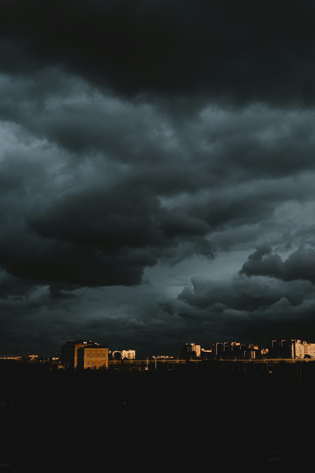 city skyline under dark clouds