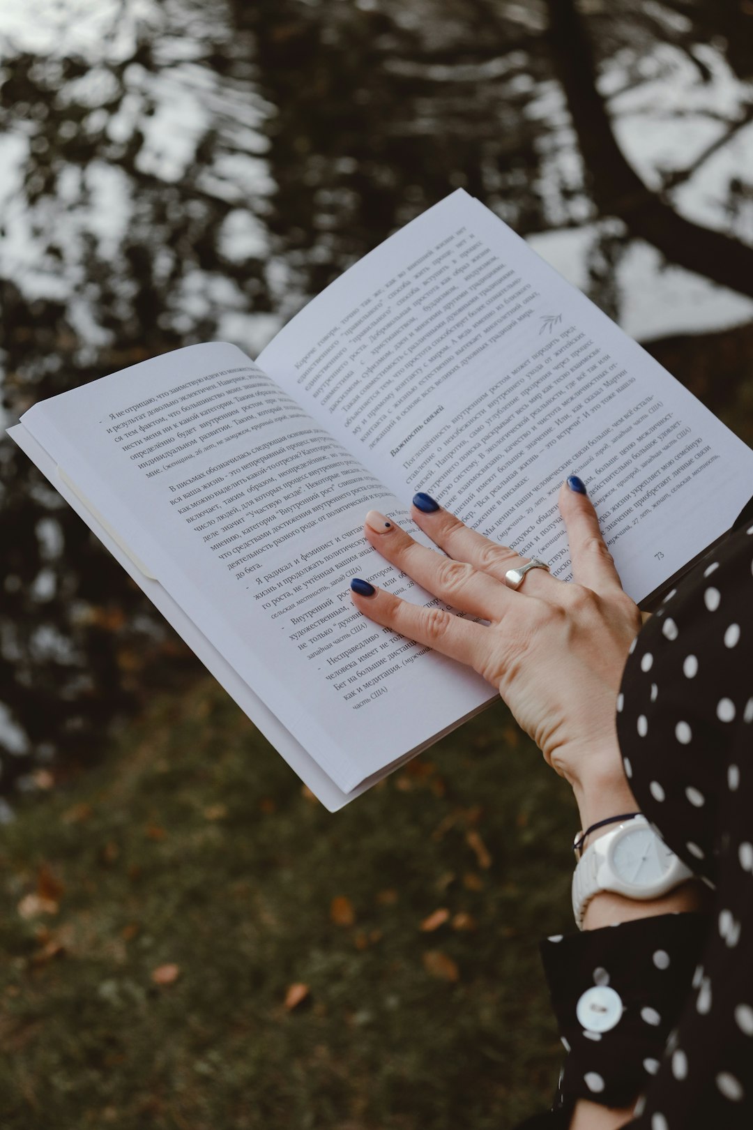 person holding white book page