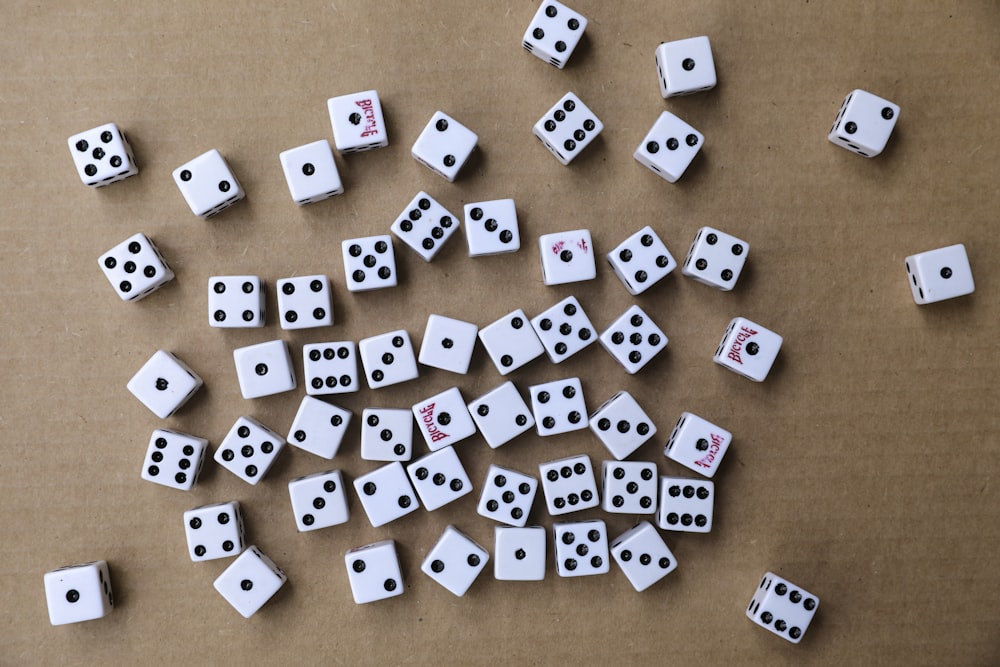 white and black dice on brown wooden table