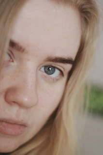 A close-up of a model illuminated by soft studio lighting, highlighting delicate details.