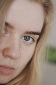 Close-up portrait showing smooth skin and warm lighting highlighting fine hair and eye details.