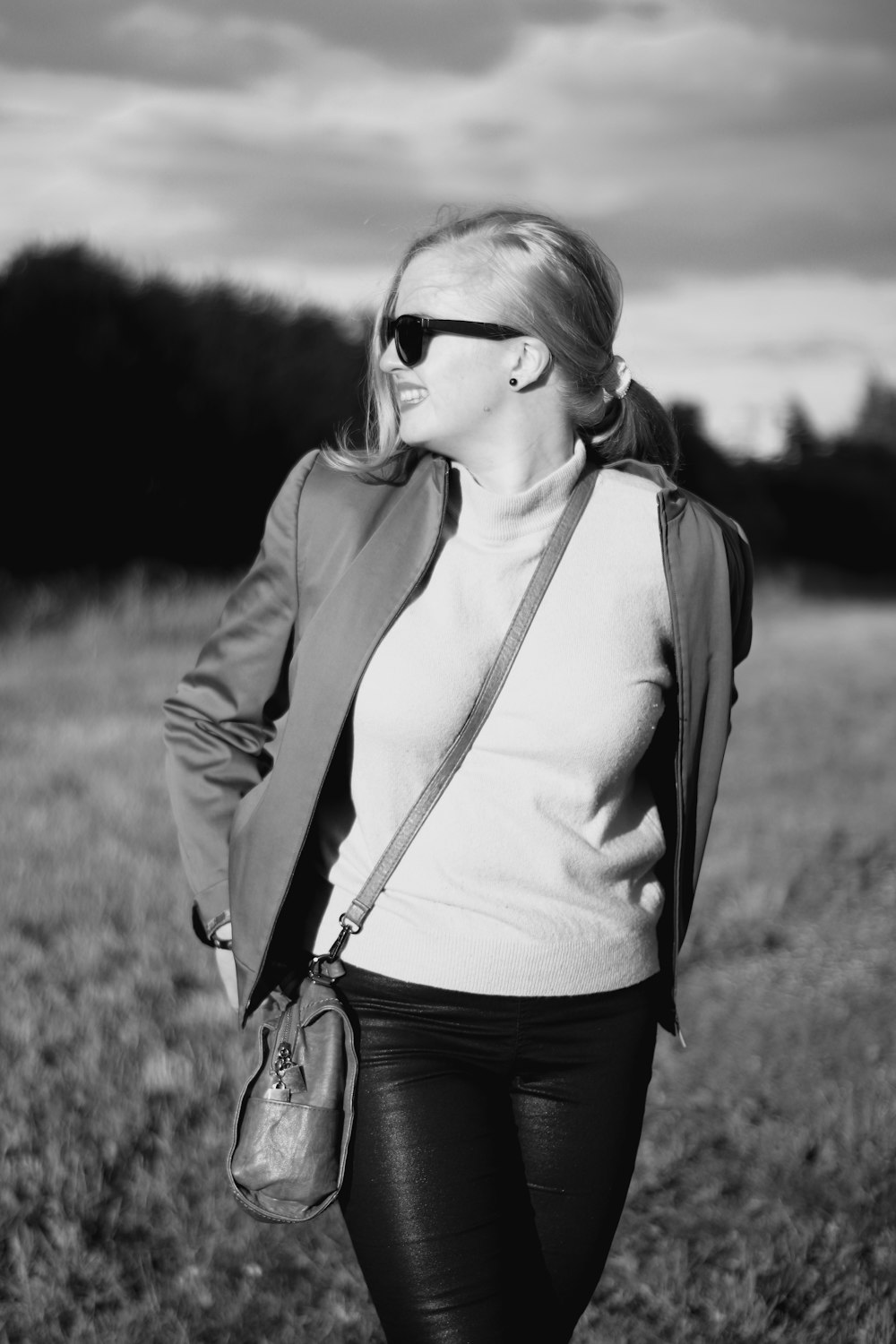 woman in white tank top and brown jacket wearing sunglasses