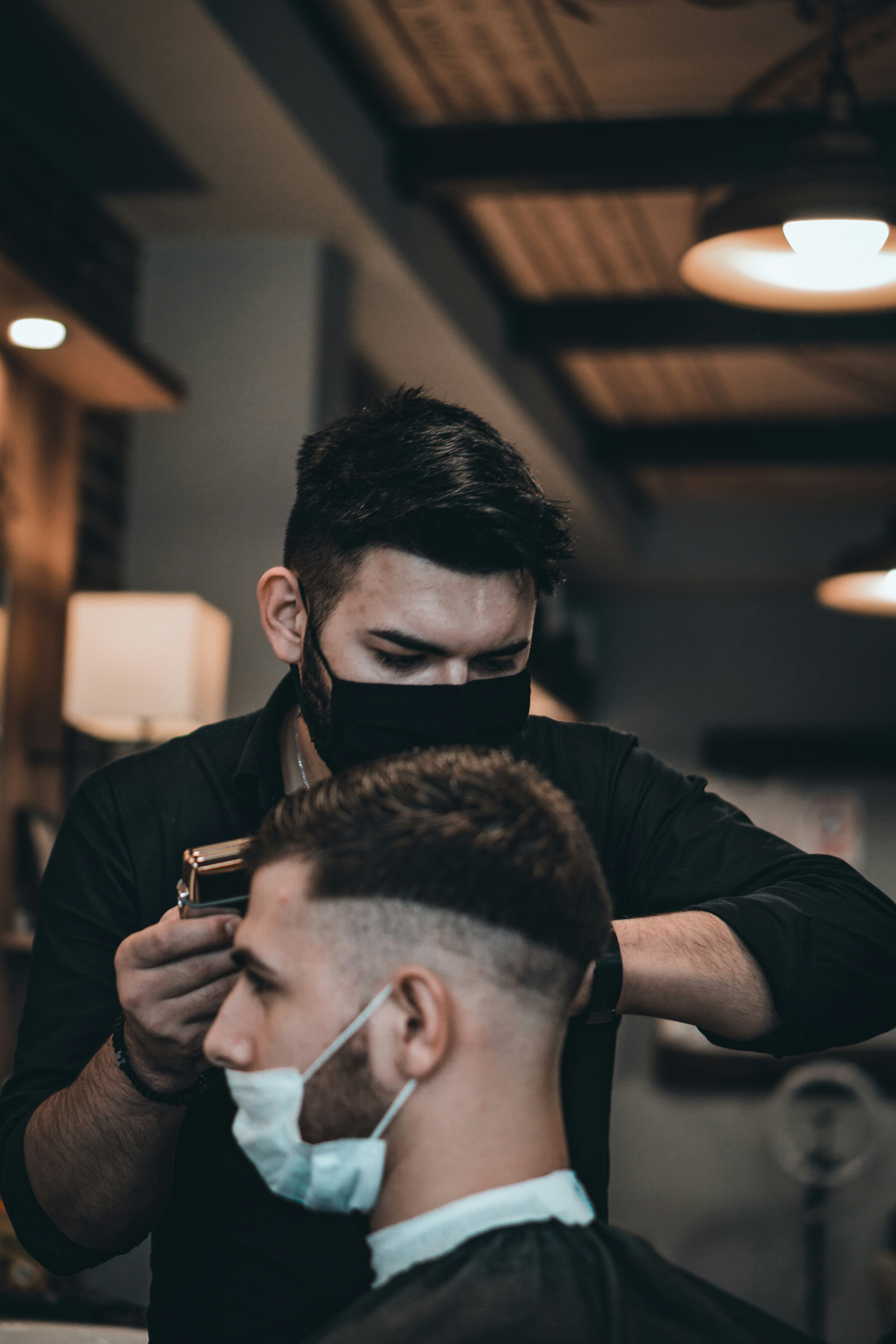 man in black long sleeve shirt holding black smartphone
