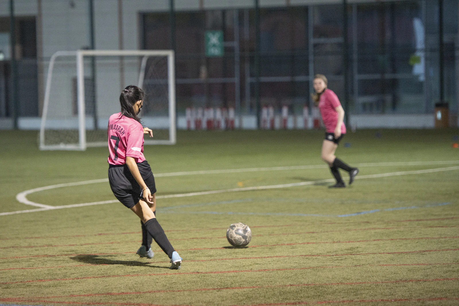 Women footballers competing for the ball during a match