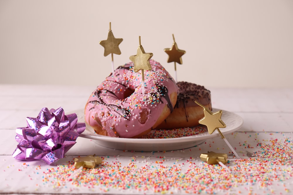 pink and brown doughnut on white ceramic plate