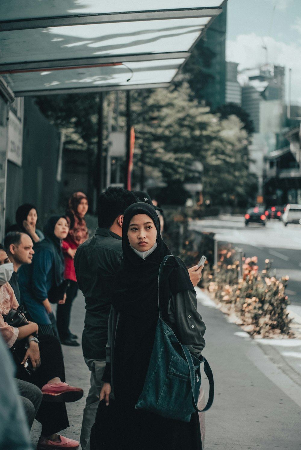 woman in black hijab standing on street during daytime