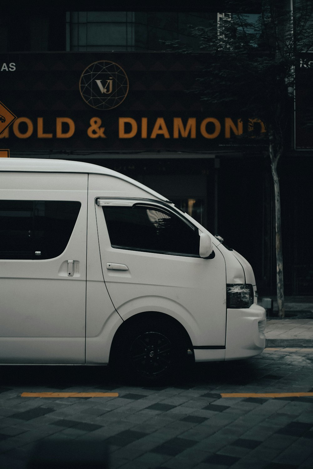 white van parked beside black wall