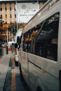 white bus on the street during daytime