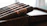 Close-up of a luxurious ebony cigar box with golden accents on a polished wooden table.