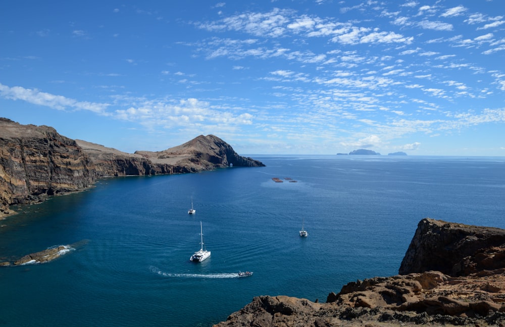 white boat on blue sea under blue sky during daytime