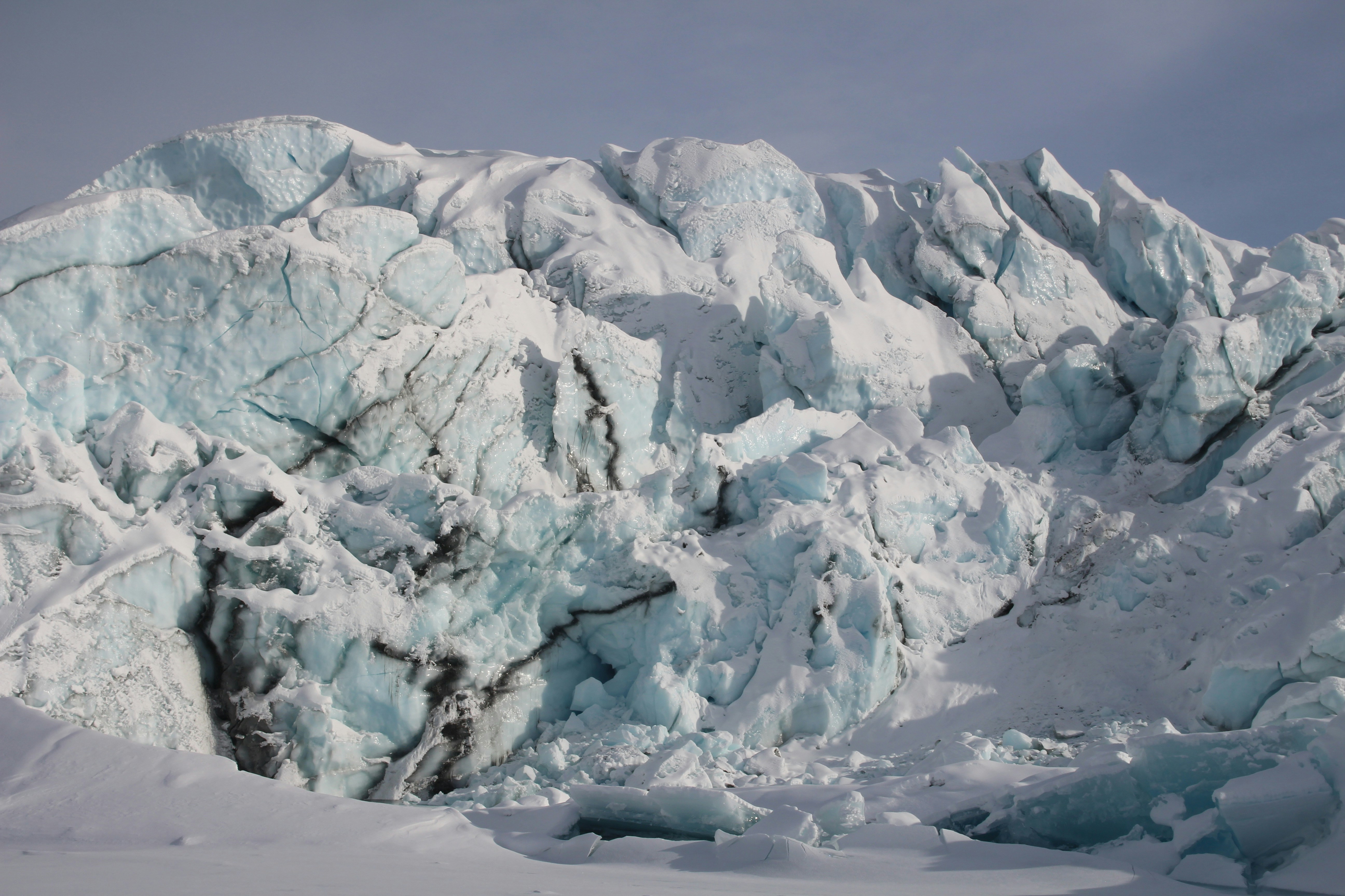 snow covered mountain during daytime, Matanuska Glacier with some black ice streaks. 