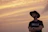 Close-up of a rugged man wearing a Redforge Legacy cowboy hat against a dramatic sunset.