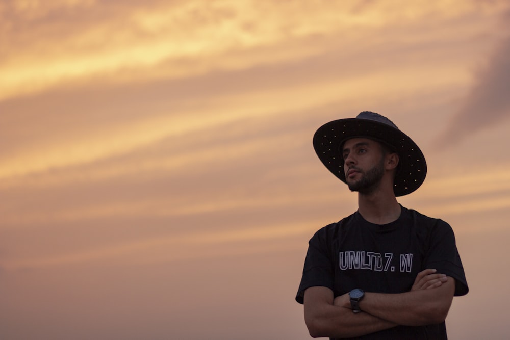 man in black cowboy hat and black crew neck t-shirt