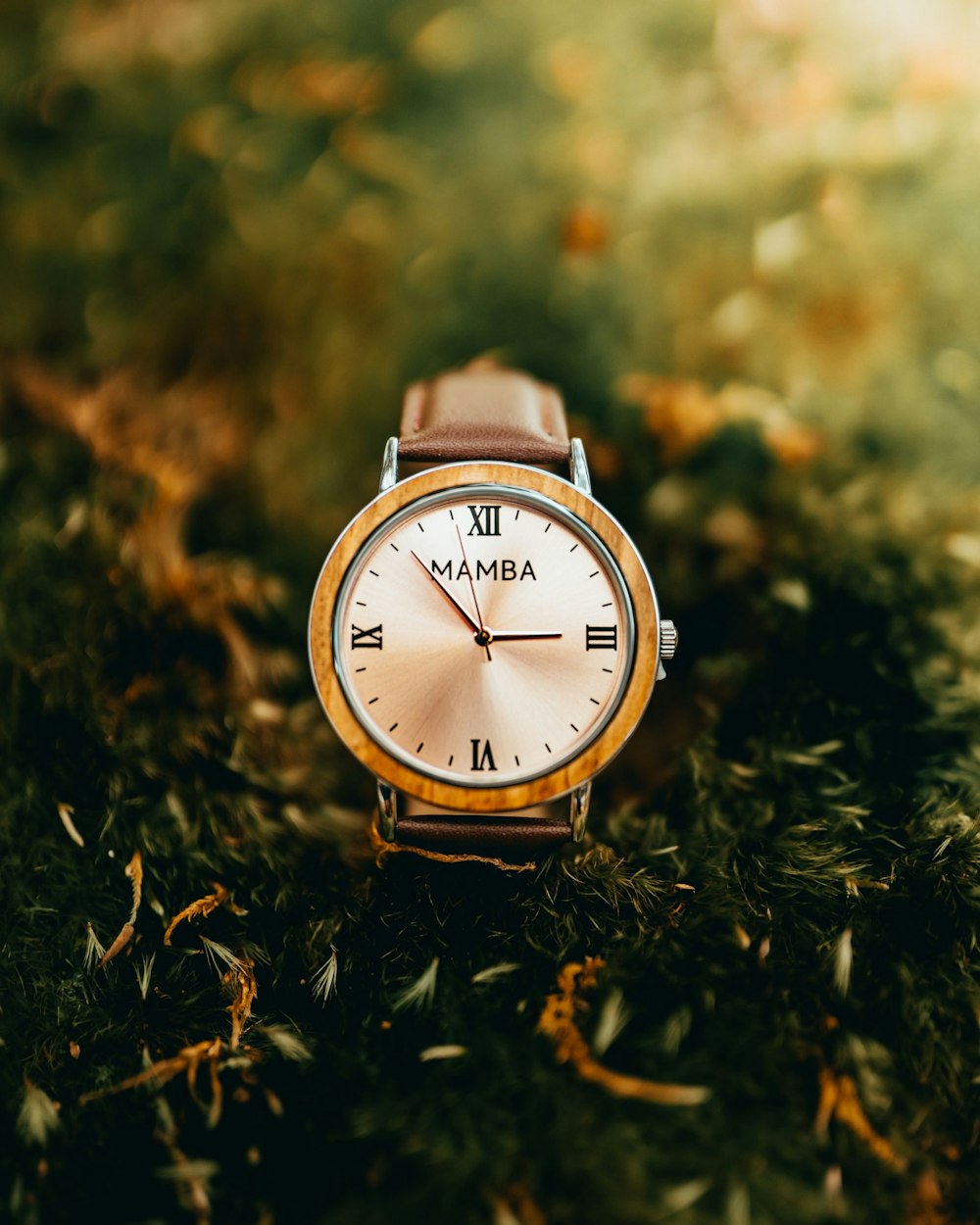 brown and white round analog watch at 10 10