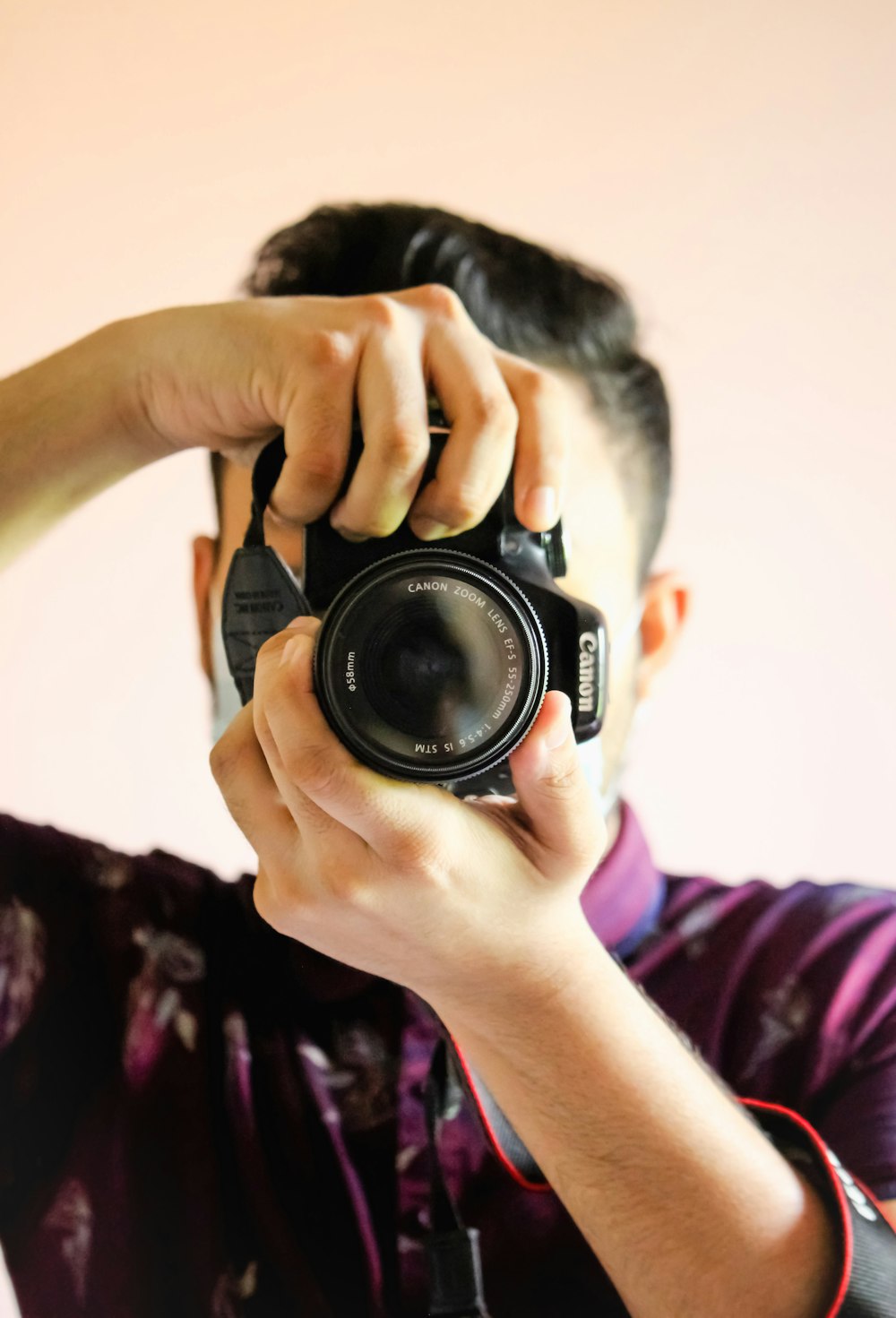 person holding black nikon dslr camera