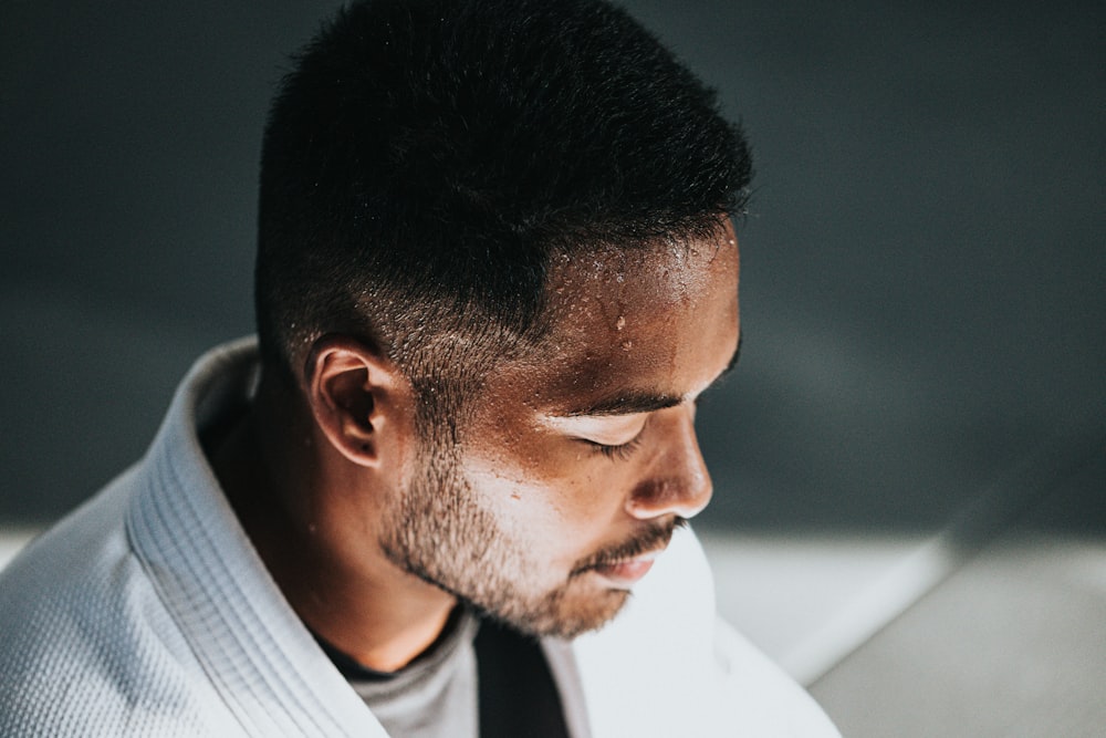 man in white shirt sitting on black chair