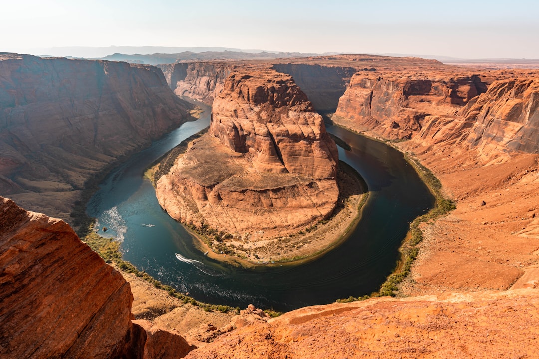 brown rock formation near body of water during daytime