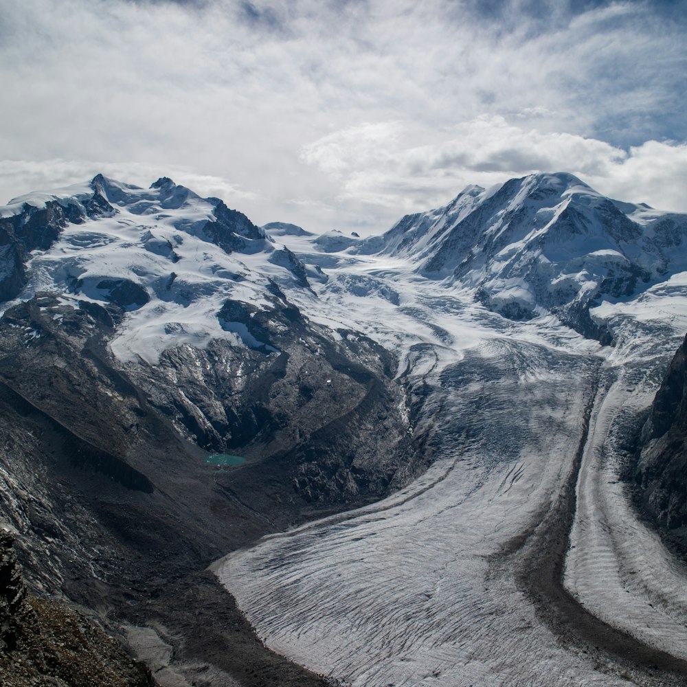 snow covered mountain under cloudy sky during daytime