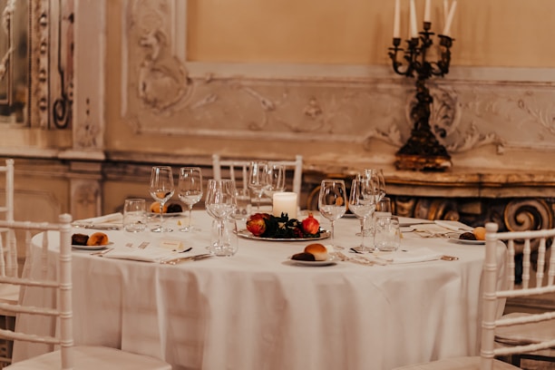 A serene image of a sophisticated dining table adorned with exquisite decor and fine tableware.