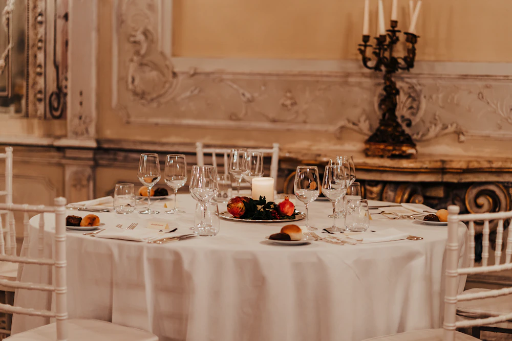 Reception table dressed in white and gold.