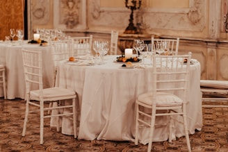 grayscale photo of dining table with chairs