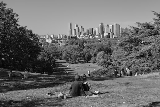 A private detective discreetly observing a couple in a city park.