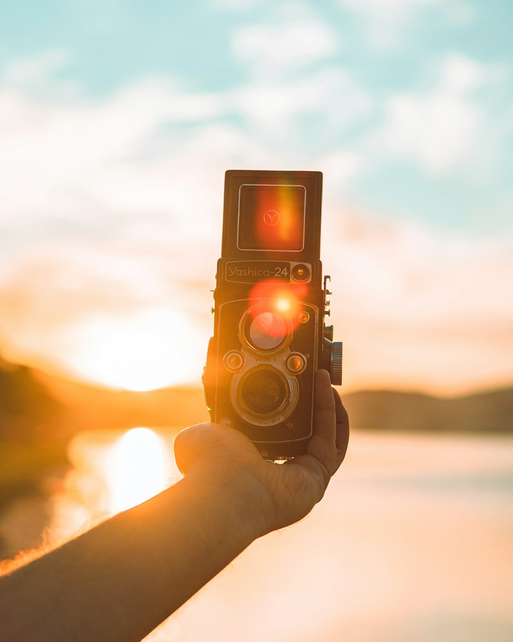 person holding black digital camera