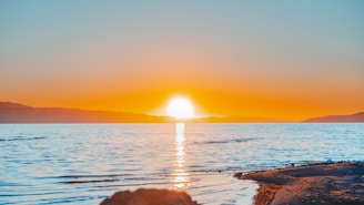 body of water during sunset