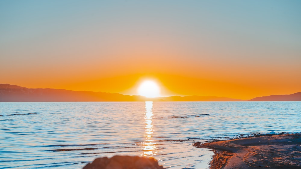 body of water during sunset