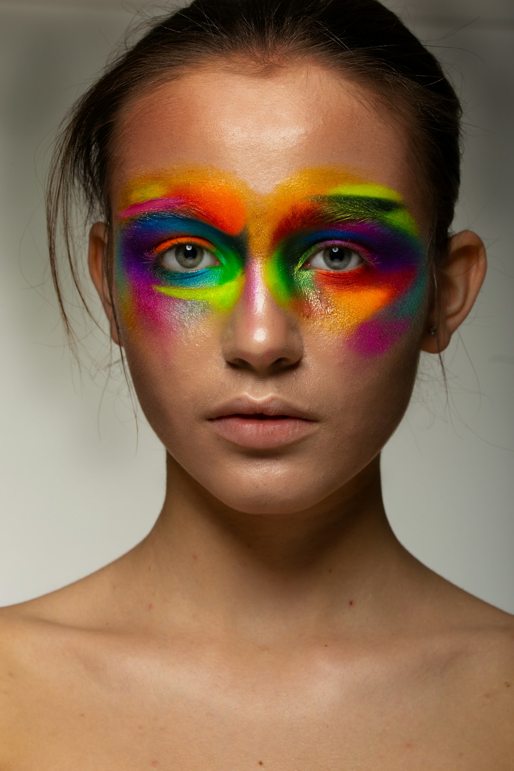 woman with green blue and purple face paint