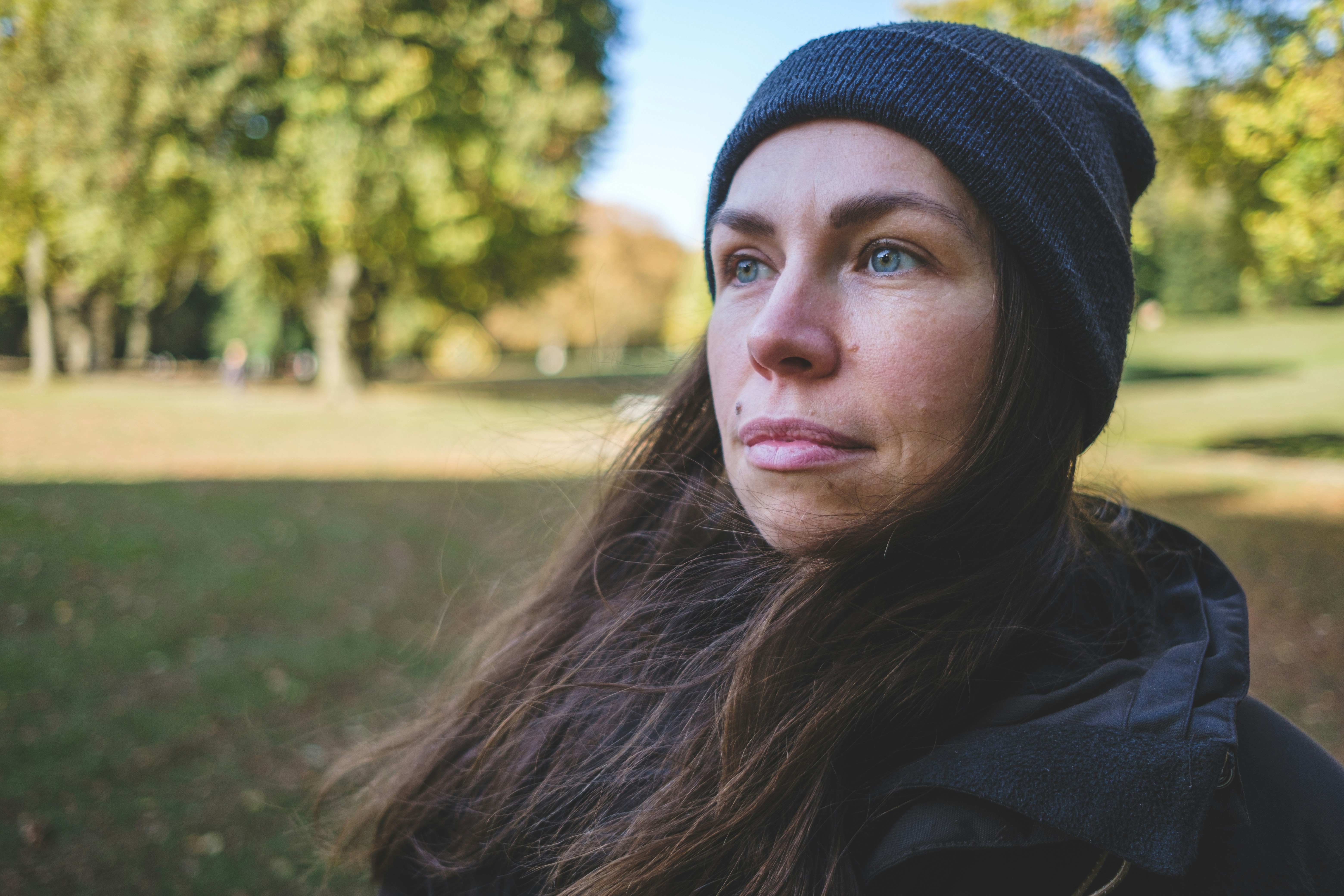 woman in black knit cap and black jacket