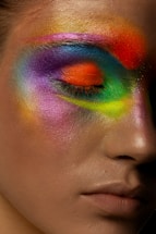 person with green orange and blue eye shadow