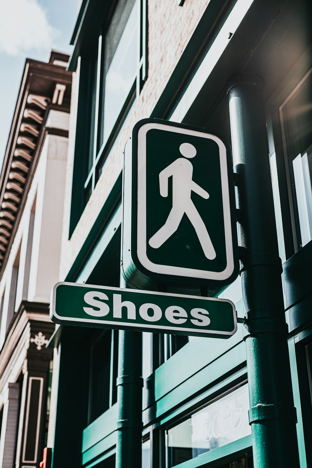 white and black pedestrian lane sign