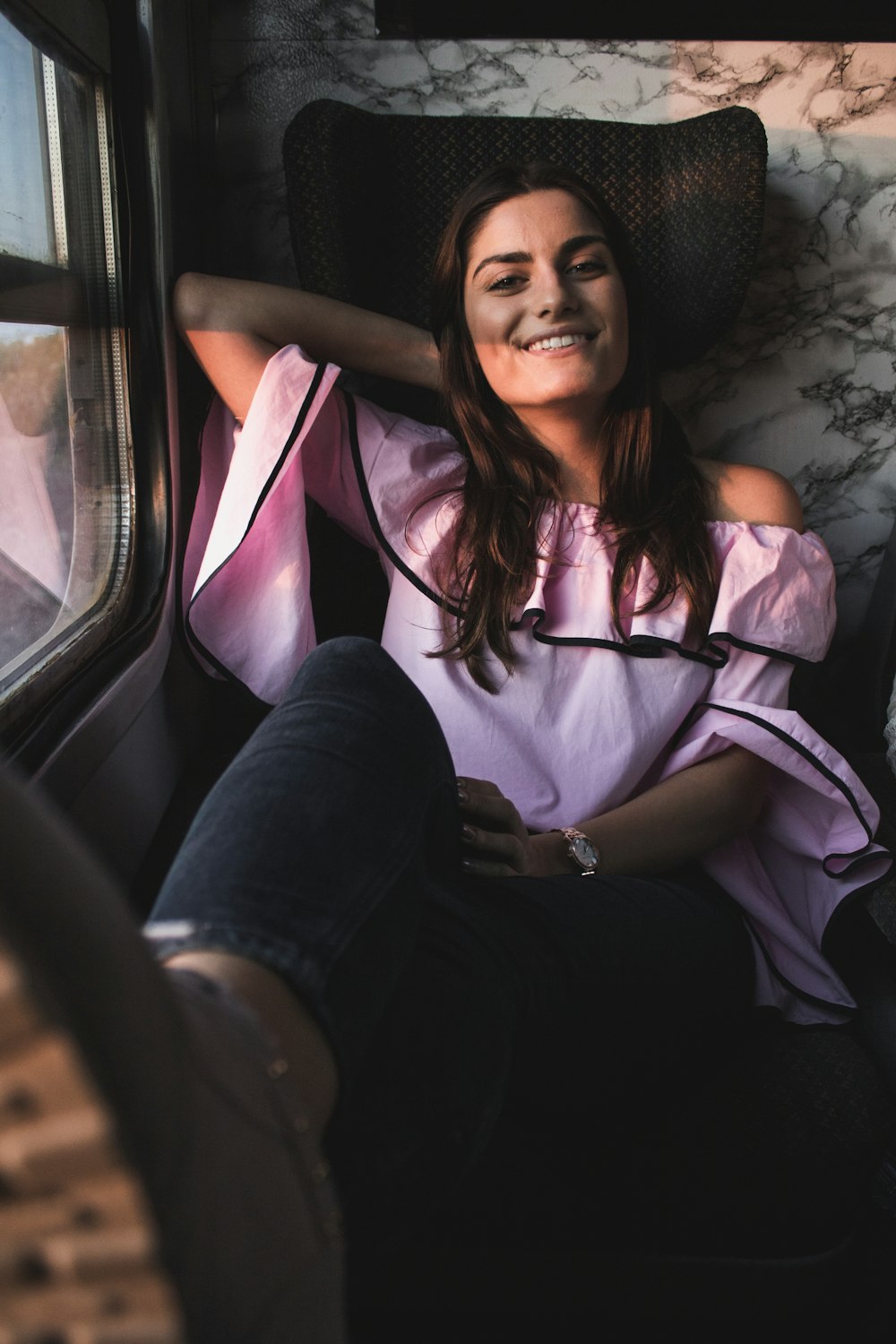 a woman sitting on a train looking out the window