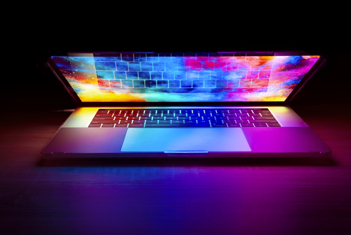 laptop halfway closed with screensaver background