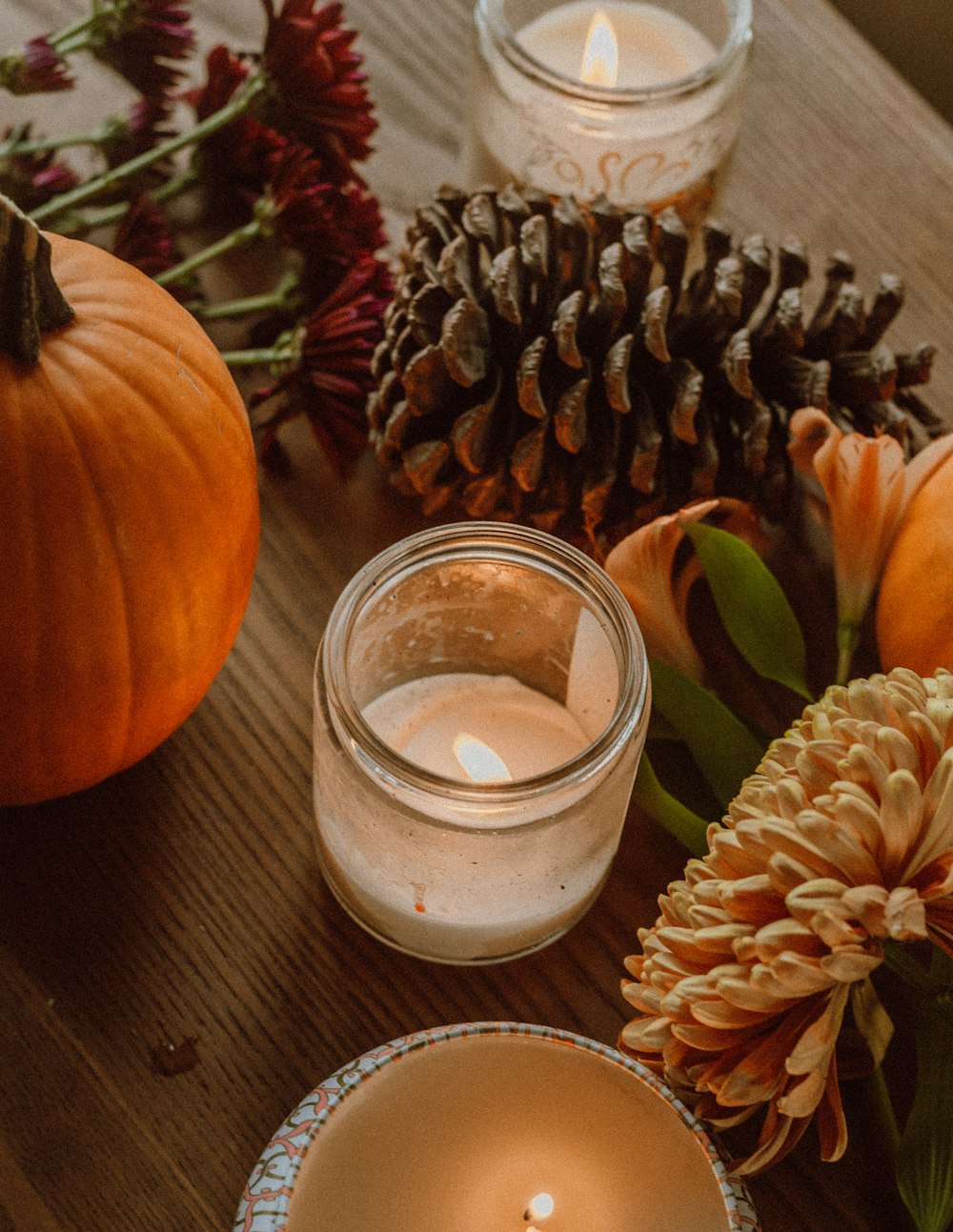 orange pumpkin beside clear glass jar with white liquid