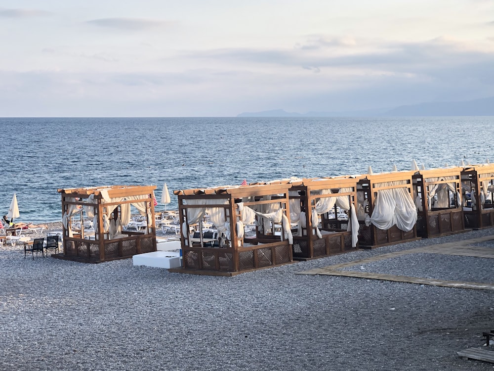 brown wooden crates on gray concrete floor near body of water during daytime