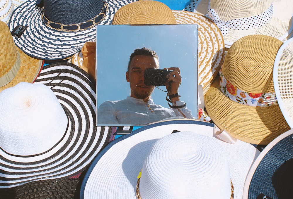 woman in black and white stripe shirt and brown sun hat