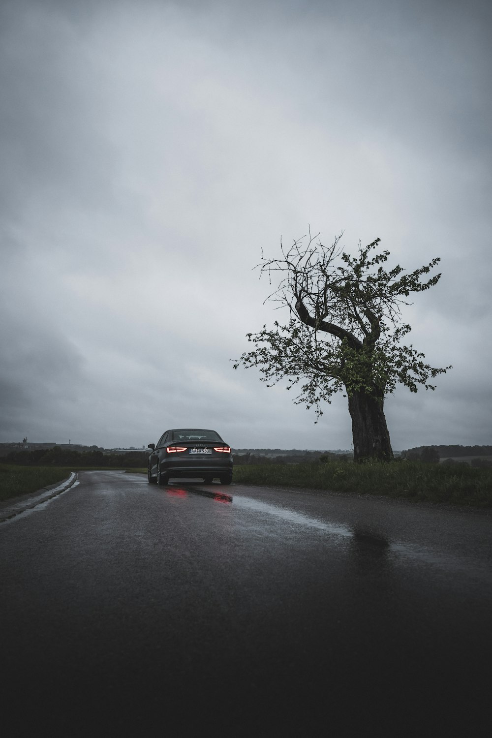 black suv on road under gray sky