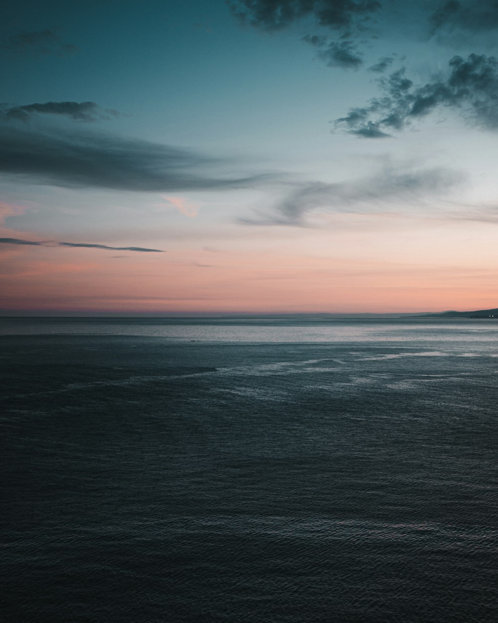 body of water under cloudy sky during daytime