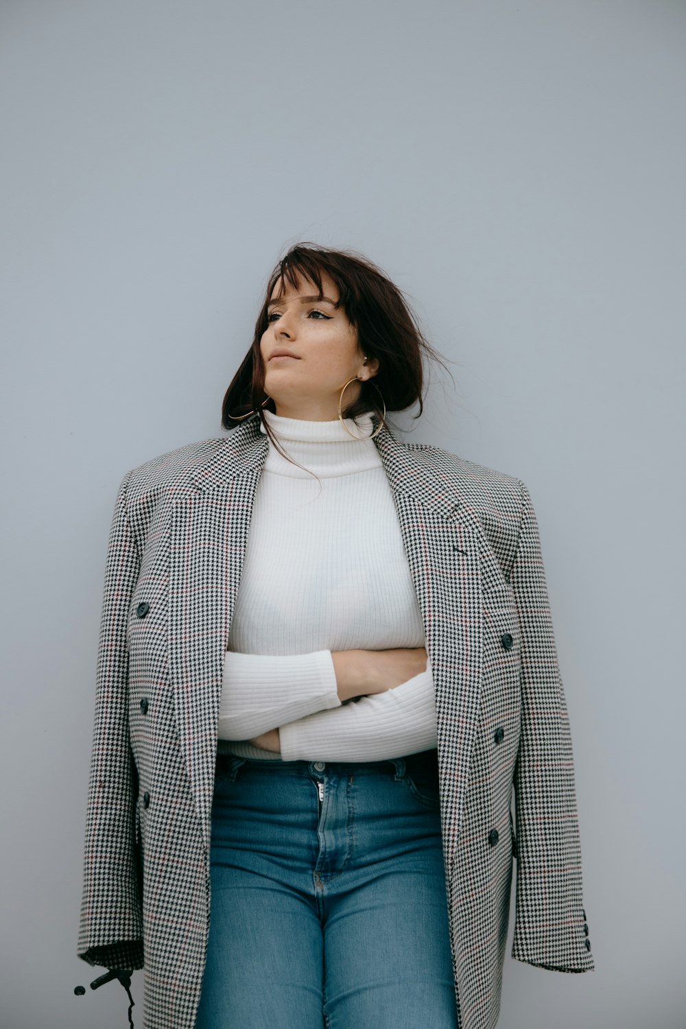 woman in white turtleneck shirt and gray blazer