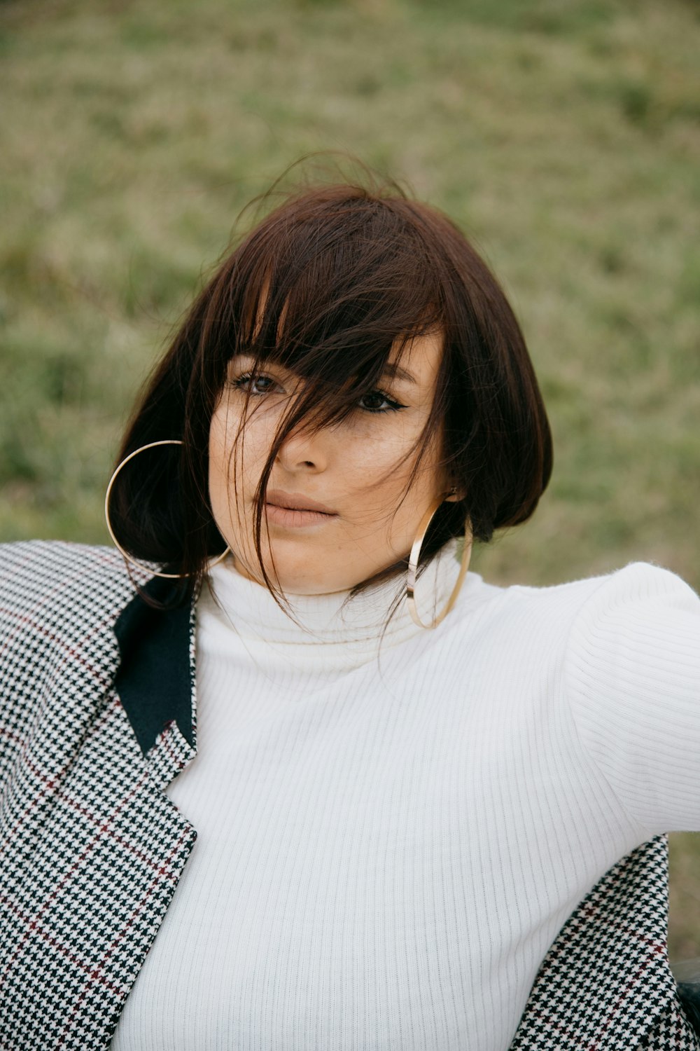 woman in white turtleneck shirt with white earbuds