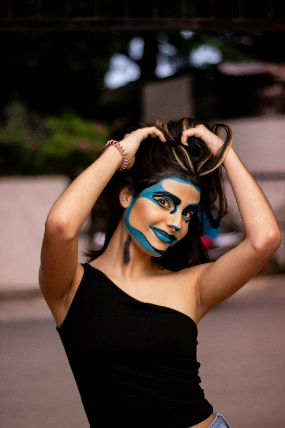 woman in black tank top with blue eyes