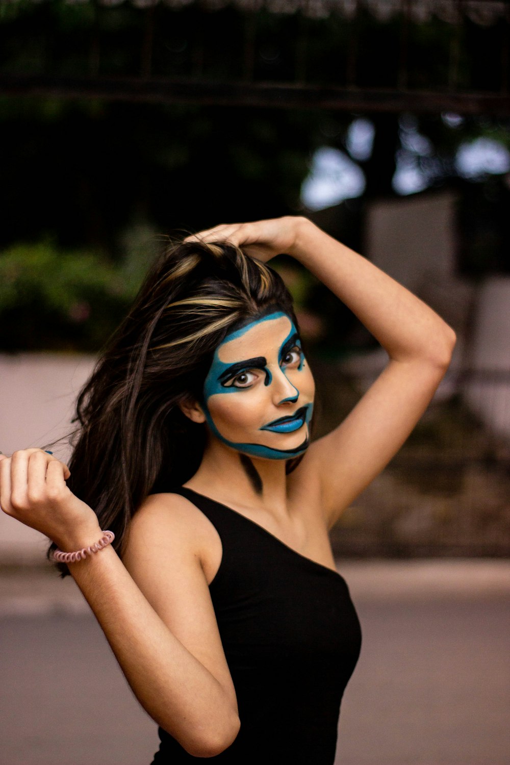 woman in black tank top with blue eyes