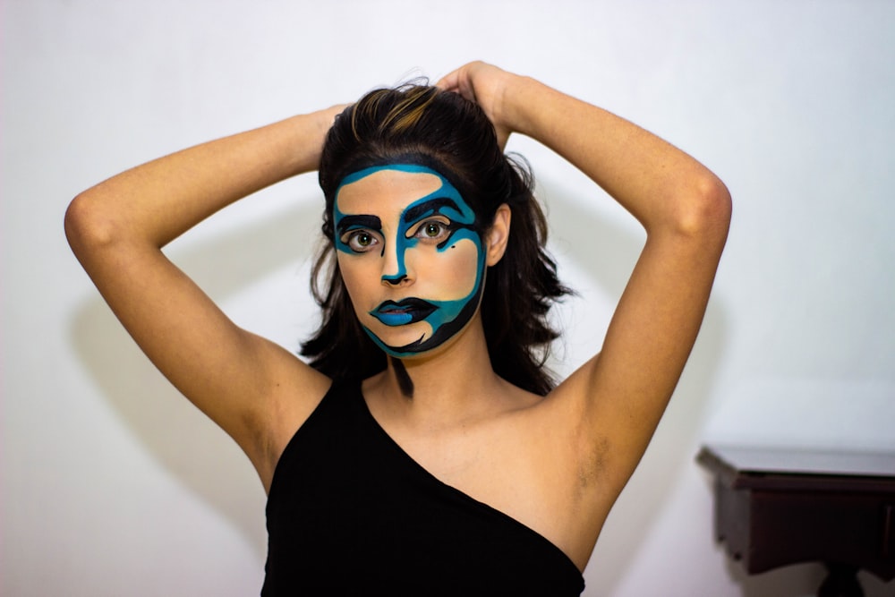 woman in black tank top with blue face paint