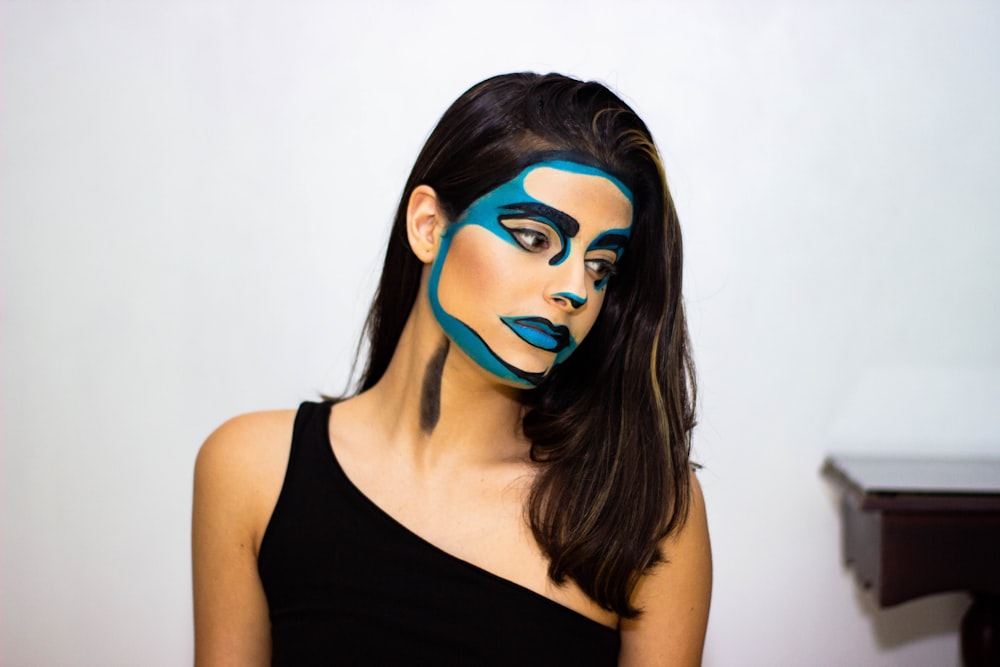 woman in black tank top with blue face paint