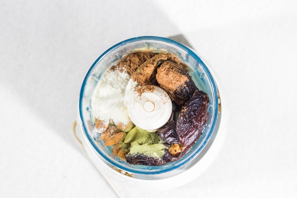 white and brown chocolate ice cream in blue glass bowl