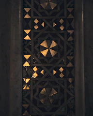 A sophisticated mosaic of dark, forest green, and gold tiles symbolizing expertise in vendor central, AI, P&L, and 360° brand strategy.