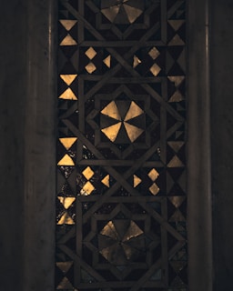 Elegant mosaic artwork featuring intricate patterns in desert-inspired beige and gold hues.