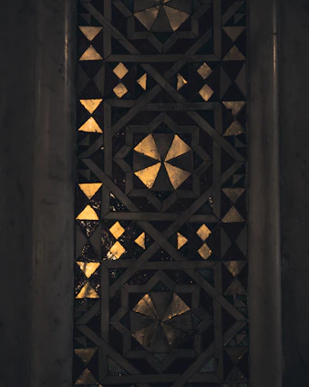 A sophisticated mosaic of dark, forest green, and gold tiles symbolizing expertise in vendor central, AI, P&L, and 360° brand strategy.